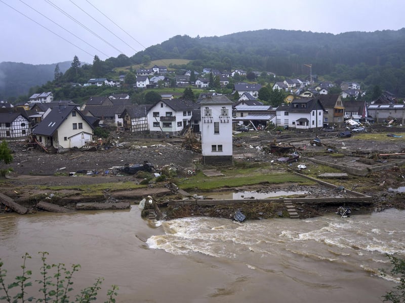 The river Ahr passes the village of Schuld, Germany, Friday, July 16, 2021 the day after the flood disaster. Heavy rains caused mudslides and flooding in the western part of Germany. Multiple have died and dozens are missing as severe flooding in Germany and Belgium turned streams and streets into raging, debris-filled torrents that swept away cars and toppled houses. (Thomas Frey/dpa via AP)