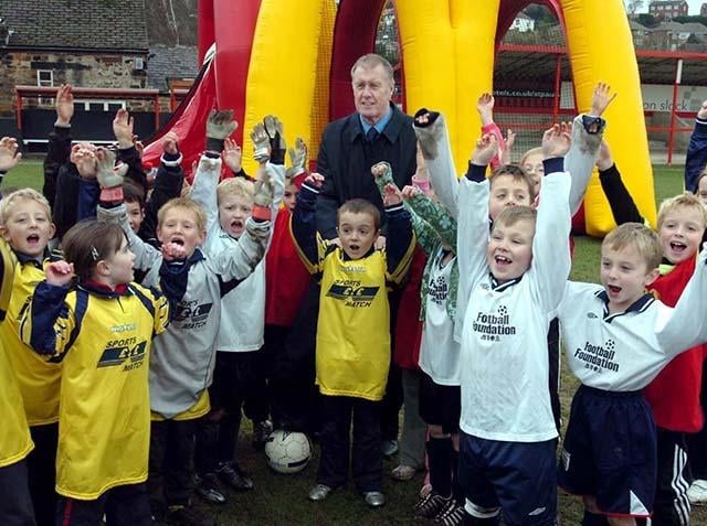 Former footballer Sir Geoff Hurst is greeted by youngsters at the Shefiield Football Festival at the Sheffield FC Stadium, Dronfield, on November 28, 2007