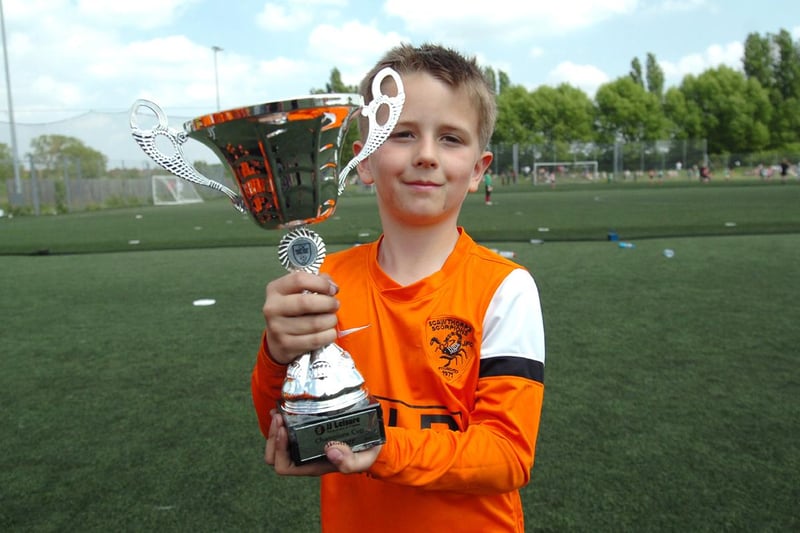 Under 7s winning captain Charlie Harmer celebrates with the cup.