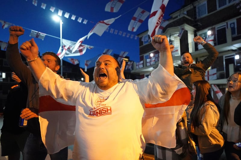Fans celebrate the goal scored by Harry Kane at Kirby housing estate in Bermondsey.
