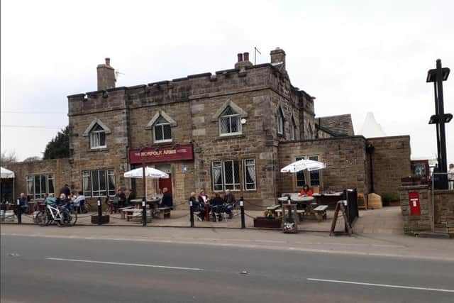 The Norfolk Arms is significant as an early Victorian public house, the original part of which retains a battlemented Gothic external character.