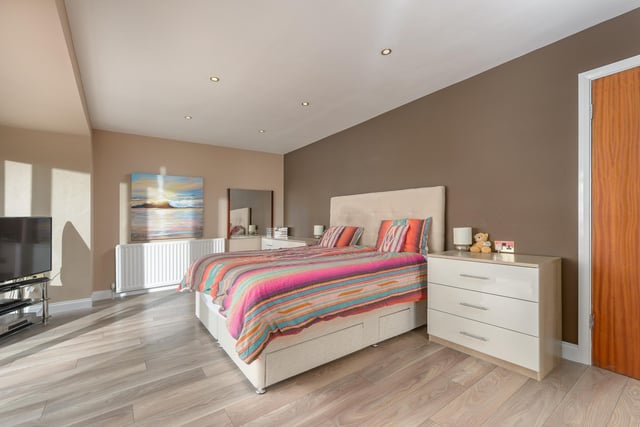 The master suite has an abundance of space with a balcony. Built-in wardrobes and drawers offer plenty of storage space and a door leads out to a further area that would make an excellent dressing room if desired, currently being utilised as a gym.