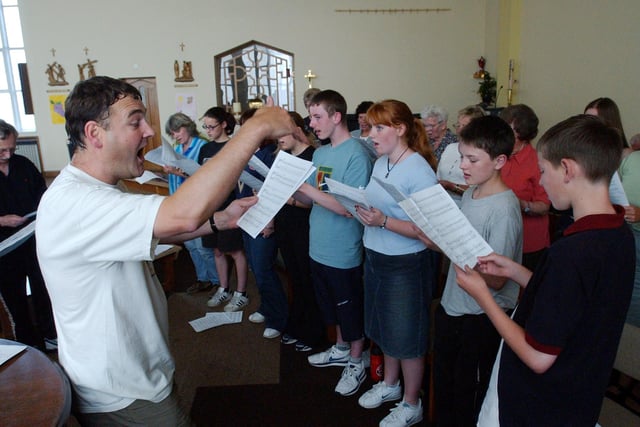 Tim Harrison leads the way in this choral reminder from 2003 at the Holy Rosary Church.