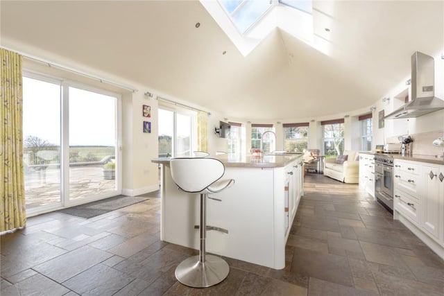 Thanks to the partially glazed ceiling and sliding doors the kitchen is extremely bright and the views over the garden are first class.