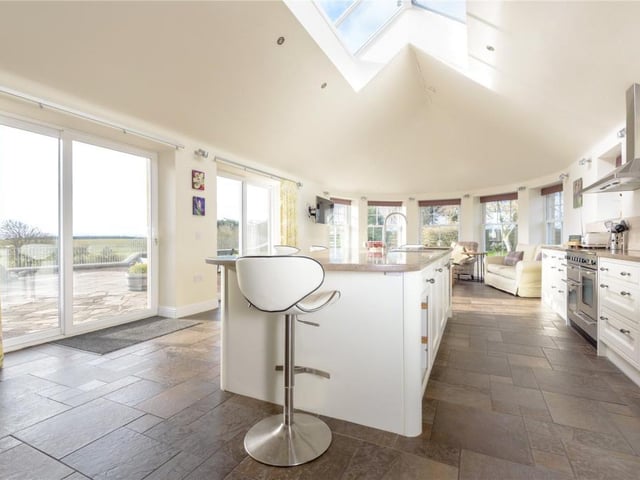 Thanks to the partially glazed ceiling and sliding doors the kitchen is extremely bright and the views over the garden are first class.