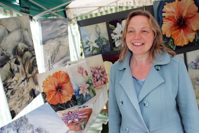 Artist Christine Walker with some of her views and flowers