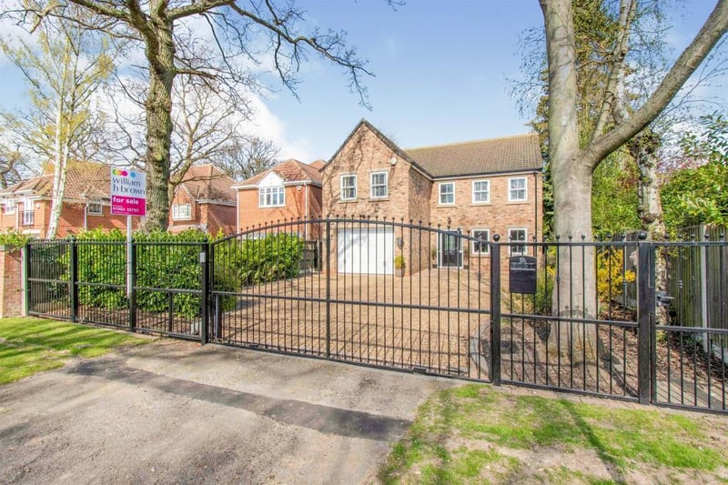 Graveled driveway providing ample off road parking which is accessed via electric gates.