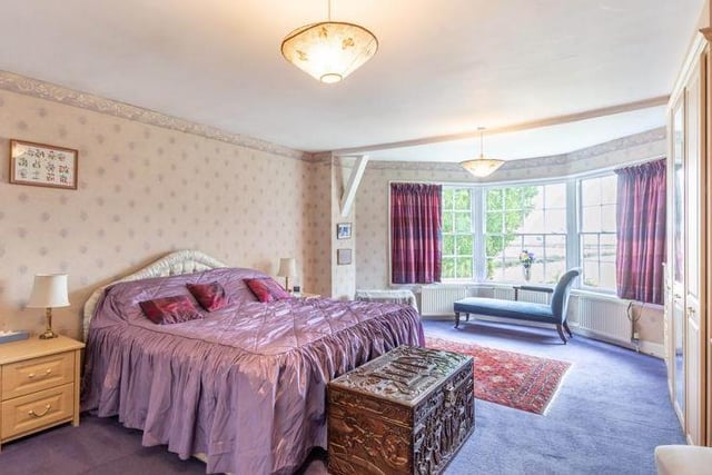 This magnificent bedroom boasts a large bay window. Natural light abounds.