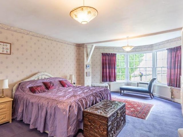 This magnificent bedroom boasts a large bay window. Natural light abounds.