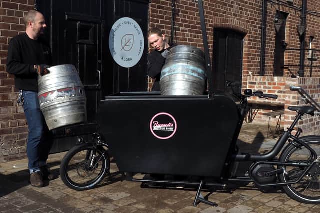 Danny Tennant  from Alder Bar Sheffield  helping load up beer barrels with Russell Cutts of Russell's Bicycle Shed Deliveries
