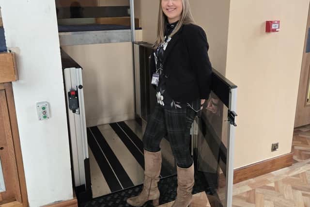 Rose Durant with the Victoria Hall's new lift, creating access to all areas of the building.