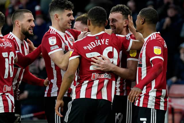 Sheffield United's jubilant players congratulate Jack Robinson on his goal against Luton, after one of the toughest spells of his career: Andrew Yates / Sportimage