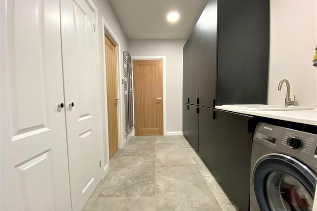 The utility room is a terrific storage and workspace. It can be used to access the kitchen from the hallway or to access the downstairs loo.