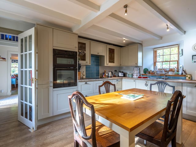 The kitchen has contemporary fittings and room for dining