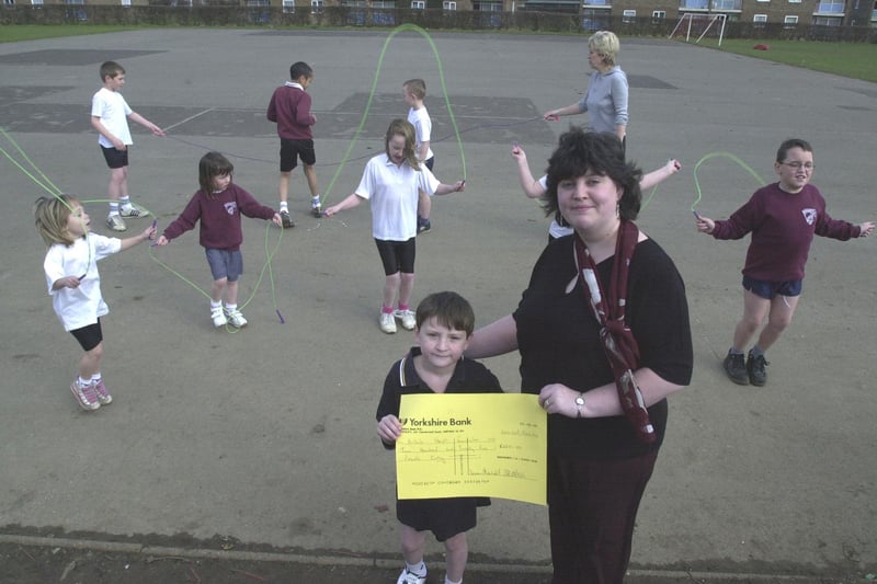 Pictured at Hemsworth Primary school, Constable Road, Sheffield, where pupils held a sponsored skipping  day to raise funds for the Heart Foundation. Seen is Angelo Dearman age 7 with Mrs Beth Stevenson, and the cheque for £225 they raised for the charity.