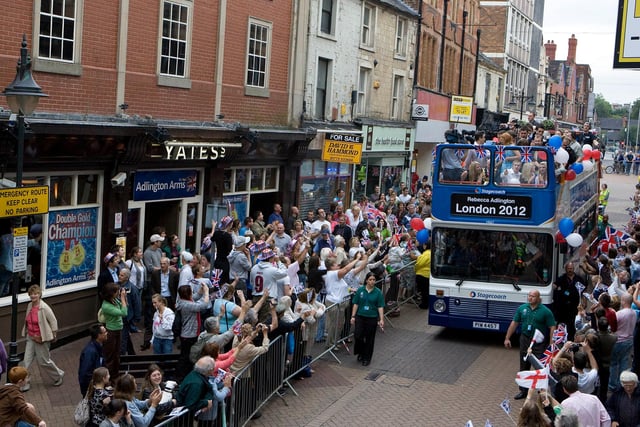 Rebecca Adlington sitting on right top deck passes the new Adlington Arms in Mansfield during her victory bus parade in 2008