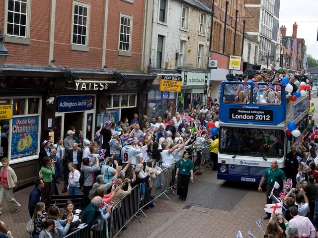 Rebecca Adlington sitting on right top deck passes the new Adlington Arms in Mansfield during her victory bus parade in 2008