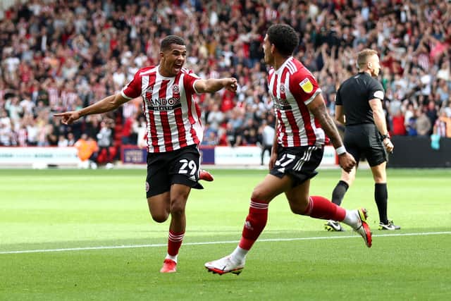 SHEFFIELD, ENGLAND - SEPTEMBER 11: Iliman Ndiaye of Sheffield United celebrates with teammate Morgan Gibbs-White (R) after scoring their side's first goal during the Sky Bet Championship match between Sheffield United and Peterborough United at Bramall Lane on September 11, 2021 in Sheffield, England. (Photo by George Wood/Getty Images)
