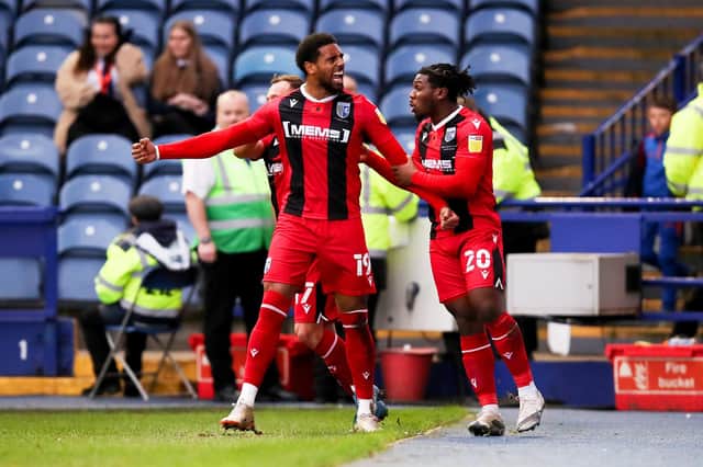 SHEFFIELD, ENGLAND - NOVEMBER 13: Vadaine Oliver of Gillingham celebrates with teammate Daniel Phillips after scoring their side's first goal during the Sky Bet League One match between Sheffield Wednesday and Gillingham at Hillsborough Stadium on November 13, 2021 in Sheffield, England. (Photo by George Wood/Getty Images)