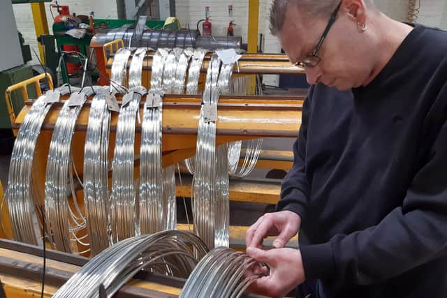 Extrusion operative Philip Collington with silver nickel wire at Thessco.
