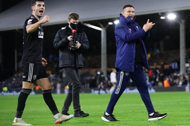 John Egan and Paul Heckingbottom enjoy Sheffield United's win at Fulham with the club's travelling fans: David Klein / Sportimage
