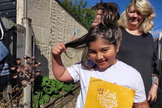 Thomas Houshmand, aged nine, is ready to lop off his 16-inches of hair to donate to the Little Princess Trust so it can be made into a wig for someone undergoing chemotherapy.