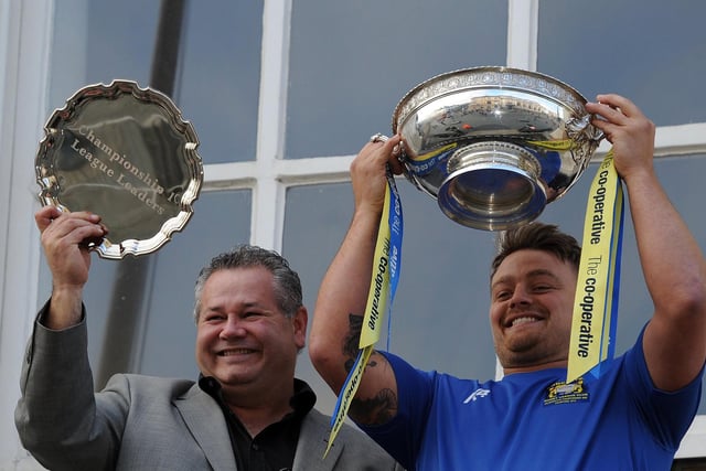 Carl Hall and Mike Emmett lift the play-off trophy and League Leaders' Shield on the Mansion House balcony.