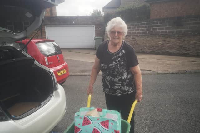 Pat Crapper, a resident of Wren Park Close, with the wheelbarrow she uses to carry her shopping from the car to the front door.