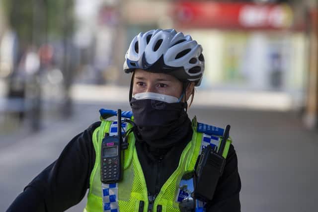 A Police Community Support Officer patrols the centre of Doncaster in a face mask for protection