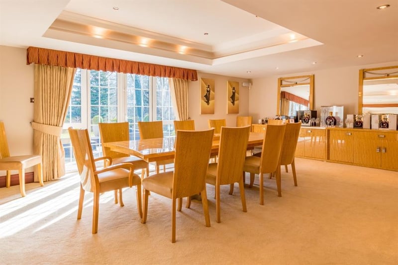Wonderfully spacious, the dining room is large enough for both family dining and entertaining guests, and features a recessed ceiling and French doors leading out to the sun terrace.