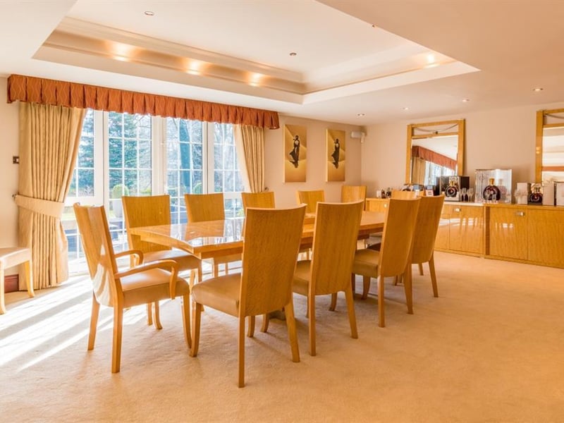 Wonderfully spacious, the dining room is large enough for both family dining and entertaining guests, and features a recessed ceiling and French doors leading out to the sun terrace.