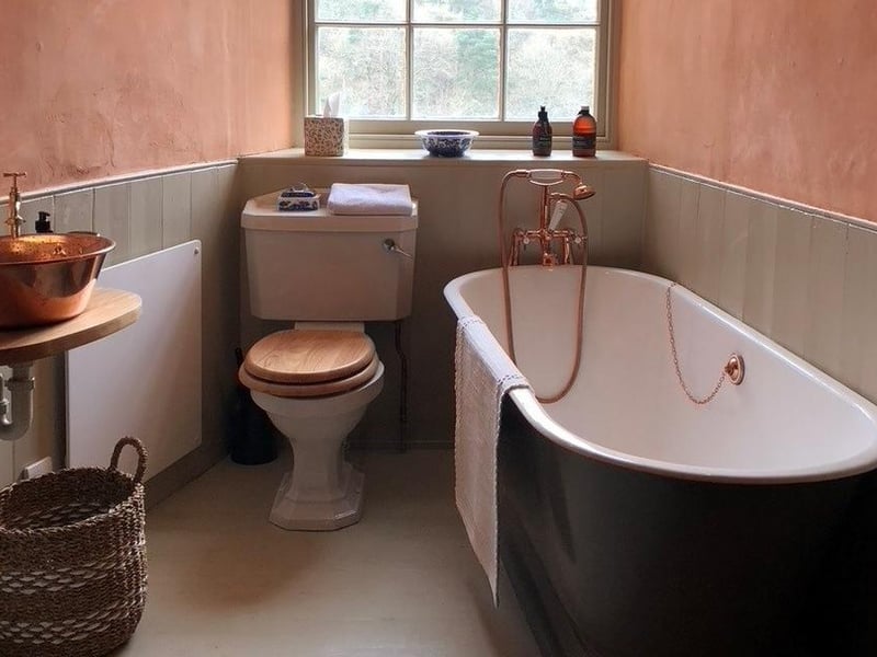 An indulgently deep rolltop bath awaits in the bathroom.