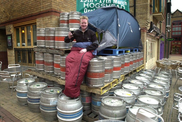 General manager of the Hoghead pub, Mark Simmonite, camps out in Orchard Square, Sheffield with the pub's consignment of Guinness which had to be stored outside before the weekends St Patrick's Day celebrations in March 2002