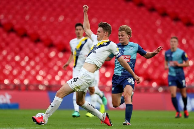 Rob Dickie of Oxford United is challenged by Alex Samuel of Wycombe Wanderers during the Sky Bet League One Play Off Final between Oxford United and Wycombe Wanderers at Wembley Stadium on July 13, 2020 in London, England.