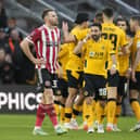 Rhys Norrington Davies of Sheffield Utd reflects as Wolves celebrate their third goal during the Emirates FA Cup match at Molineux, Wolverhampton: Andrew Yates / Sportimage