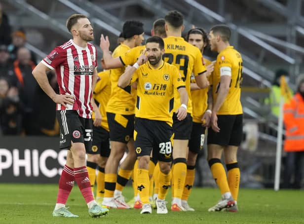 Rhys Norrington Davies of Sheffield Utd reflects as Wolves celebrate their third goal during the Emirates FA Cup match at Molineux, Wolverhampton: Andrew Yates / Sportimage
