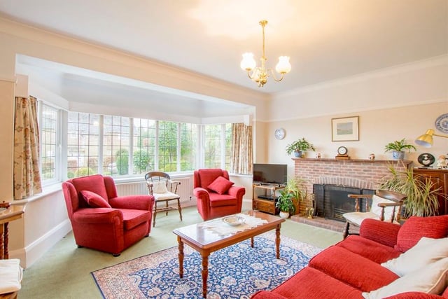The large sitting room has a bay window and an open fire.