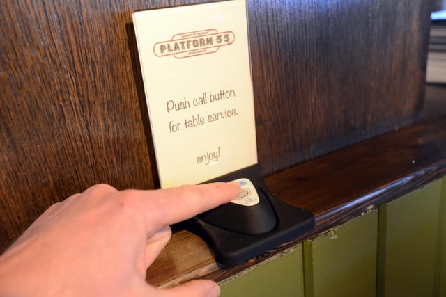 Booths are fitted with call buttons - linked to watches worn by the staff - to request table service.