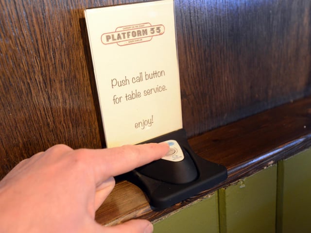 Booths are fitted with call buttons - linked to watches worn by the staff - to request table service.