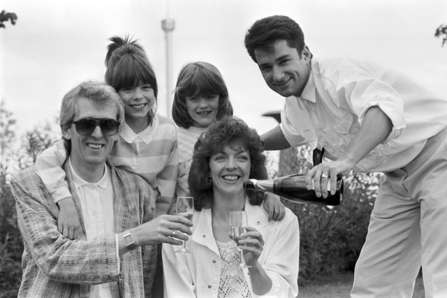 TV presenter Paul Coia pours champagne for Keith Dunn, here with his wife and daughters. Mr Dunn was the 1,000,000th visitor to the Glasgow Garden Festival in June 1988.