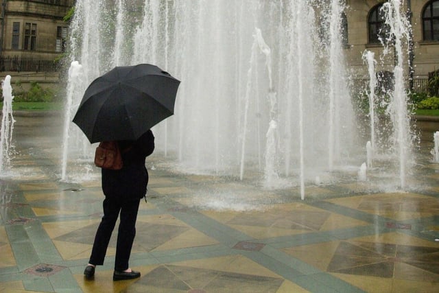  A visitor braves the cold and rain to take a close look at the fountain in the Peace Gardens Sheffield during the May day bank holiday yesterday (monday)See Pics from 1999 in warmer weather...   ..Pictures Chris Lawton  6th May  2002