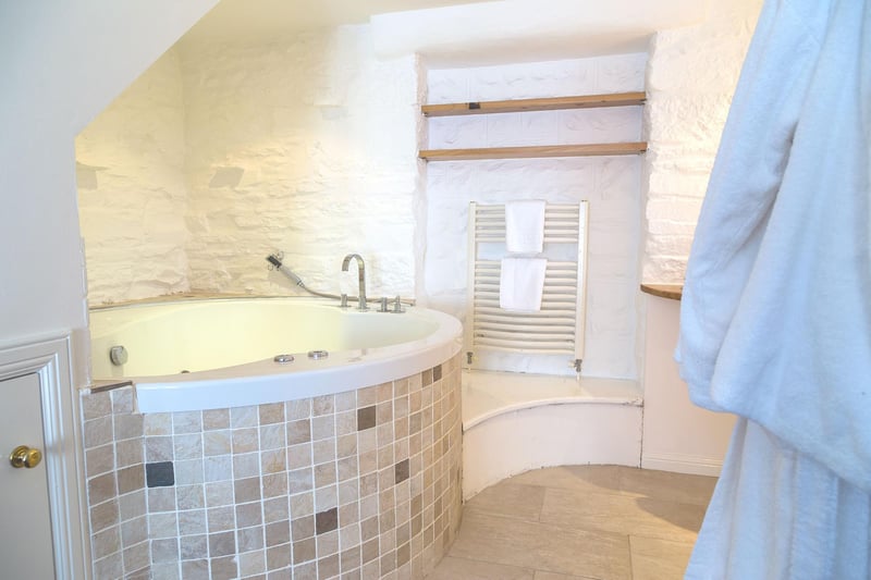 The ensuite bathroom includes a whirlpool bath large enoough for two.