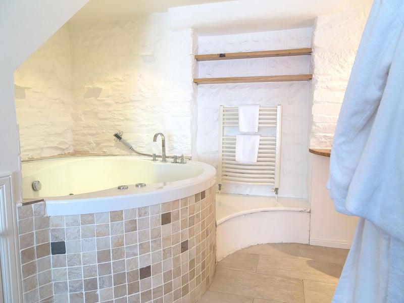 The ensuite bathroom includes a whirlpool bath large enoough for two.