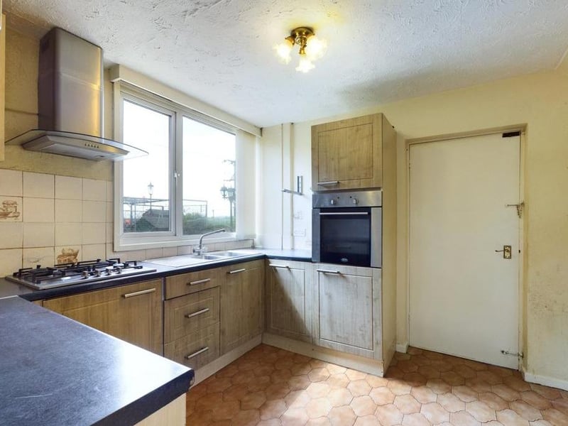 Kitchen with fitted appliances