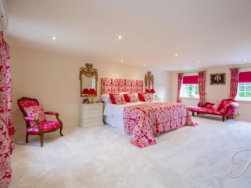 The delightful main bedroom. Very spacious, it boasts a carpeted floor, double windows to the front and back, and central heating.