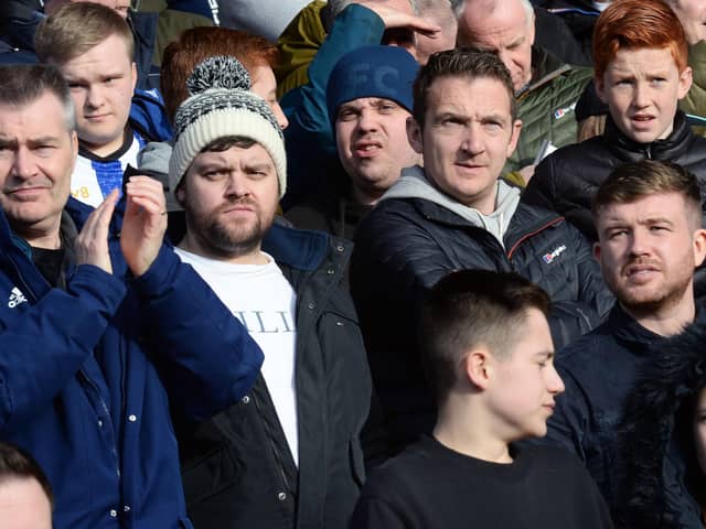 Owls supporters watch their side do battle with South Yorkshire rivals Barnsley.