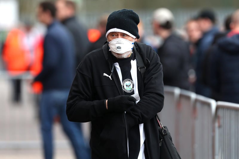 A Newcastle United fan wears a face mask before the club's 1-0 win at Southampton on March 7, 2020, which is still the last game Toon fans have been able to attend.