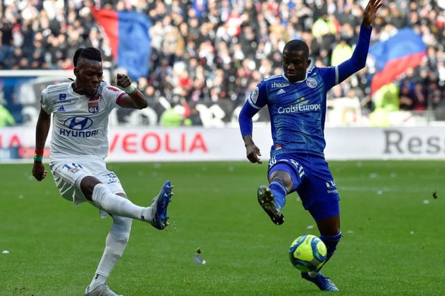 Lyon's Burkinabe forward Bertrand Traore (L) fights for the ball with Strasbourg's Ivorian forward Kevin Zohi (R) during the French L1 football match between Lyon (OL) and Strasbourg (RCSA) on February 16, 2020 at the Groupama Stadium in Decines-Charpieu near Lyon, southeastern France.