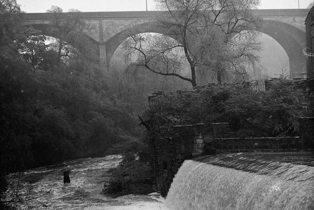 The Water of Leith in flood at Dean Village, with Dean Bridge in the background, in July 1954.