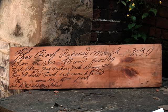 While working on the roof restoration at Wentworth Woodhose, a trio of Carpenter/Joiners, uncovered a roof board with a inscription etched into from 1830. Seen with the board (left to right) are: Richard Holden, Joe Hutchinson and Jack Richmond, who are sub-contracted by Jericho Joinery for the Woodhead Group. The trio are seen in the Van Dyk room, where the board was found in the roofspace above them. (ends)